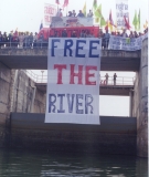 Community members lower a banner over the Rasi Salai Dam during the International Day of Action for Rivers in 2000