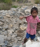 Girl digs for gold at Xayaburi Dam site