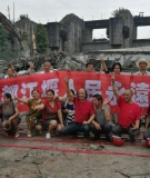 Dujiangyan community members celebrating the demolition of the Shengxing power station.  The banner reads “We will protect you forever, Dujiangyan World Heritage Site!”
