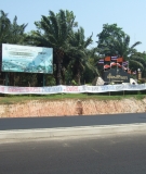 At the main entrance to Sirindhorn Dam, a protest banner denounces a proposed nuclear power station, claiming it will further destroy livelihoods of local dam-affected people.