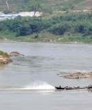 A boat powers down the Irrawaddy River in Burma, which would have been affected by the Myitsone Dam.
