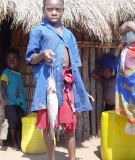 Girl with fish, Zambezi river, Mozambique