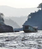 A 'slow boat' sails the Mekong River near the Pak Beng dam site, down-river from Chiang Kong.