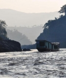 A boat makes its way down the Mekong River near the proposed Pak Beng Dam site, downstream of Chiang Khong district, Chiang Rai. Dam building on the lower Mekong is accelerating, and it threatens to leave a path of destruction in its wake.