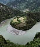 Springing from Tibetan glaciers and flowing to the Andaman Sea, China's Nu River sluices around a horseshoe bend near Bingzhongluo in Yunnan Province. Plans to build a cascade of dams down the river now appear to be on hold. 