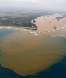 An aerial view of the Rio Doce at an area where the river joins the sea, on the coast of Espírito Santo in Regência village. 