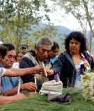 Berta Caceres lights candles with Lenca community members.