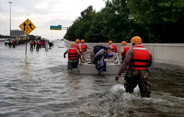 Soldiers with the Texas Army National Guard move through flooded Houston streets as floodwaters from Hurricane Harvey continue to rise, Monday, August 28, 2017. More than 12,000 members of the Texas National Guard have been called out to support local authorities in response to the storm.