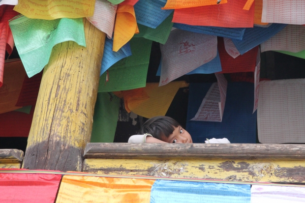 Little girl from Nu minority at a Tibetan river ritual.