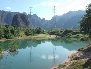 Power lines cross the Hinboun River to bring electricity to Thailand.