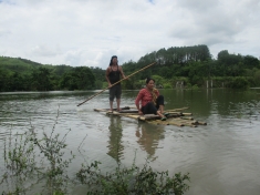 People cross the reservoir in bamboo rafts and wooden canoes after the submergence of the only bridge that connected the valley
