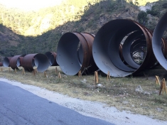 The penstock components lie by the roadside and give an indication of the quantum of water that will turn the turbines of Punatsangchu I & II