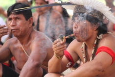 A man enjoys a pipe during the Kari-Oca II gathering outside Rio.