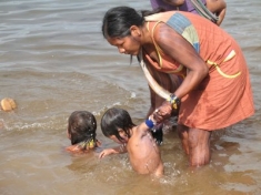 Kayapó women bathe their children in the waters of the Amazon's Xingu River.
