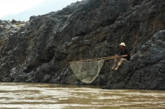 A fisherman waiting for his catch along the Mekong River