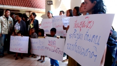Communities from along the Mekong River protests outside the consultation meeting for the Don Sahong Dam.