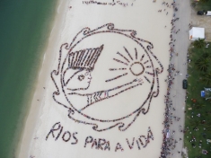 Human banner on the beach in Rio reads 