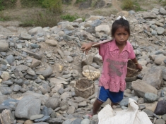 Girl digs for gold at Xayaburi Dam site