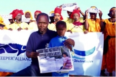 Bargny Waterkeeper Alliance in Senegal demonstrates for the International Day of Action for Rivers, with several individuals holding photos of Berta. 
