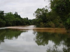 The dirty Macal River meets the Mopan River, Belize