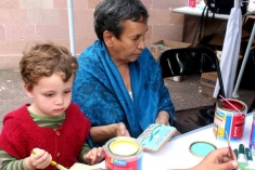 A child from Temaca making tiles with one of the Innu women participants from Quebec.
