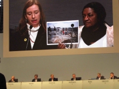 Monica Brito, representative of Movimento Xingu Vivo, showing images of destruction by Belo Monte at Siemens's shareholders meeting