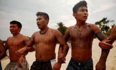 Members of the Munduruku indigenous tribe dance along the Tapajós river during a ‘Caravan of Resistance’ protest in November. 