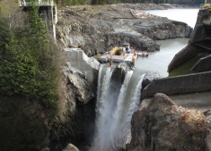 The top quarter of Glines Canyon Dam was removed from the Elwha River with a hydraulic hammer on a barge anchored upstream of the dam.