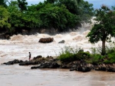 A fisher going to set his fishing gear at rapids at Don Sahong on the Mekong River. 