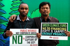 Two men protest to keep the Green Climate Fund clean in Bali. Feb, 2014