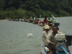 FIshermen form a line to block access to the construction site of a coffer dam on the Xingu River