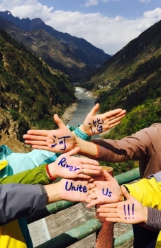 Rivers Unite Us! Chinese rier activists make a statement at one of China's rare undammed rivers to celebrate the 2015 International Day of Action for Rivers.