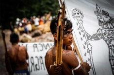 A Munduruku warrior prepares to occupy the São Manoel dam during a protest. 