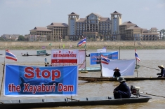 Laotian territory provides a backdrop as Thai activists and villagers affected by the controversial Xayaburi Dam express their opposition on the Mekong River in Nong Khai province on November 5.