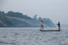 Fisher throws cast net, Sekong River - 2008