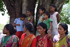 Women and girls listen in Gazadoba Village No. 12 during a cross-border exchange.